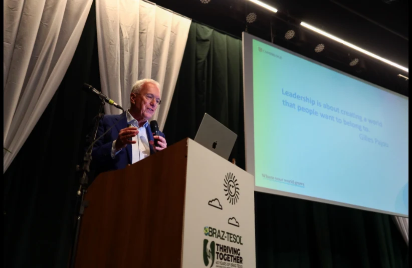Speaker presenting at the conference podium